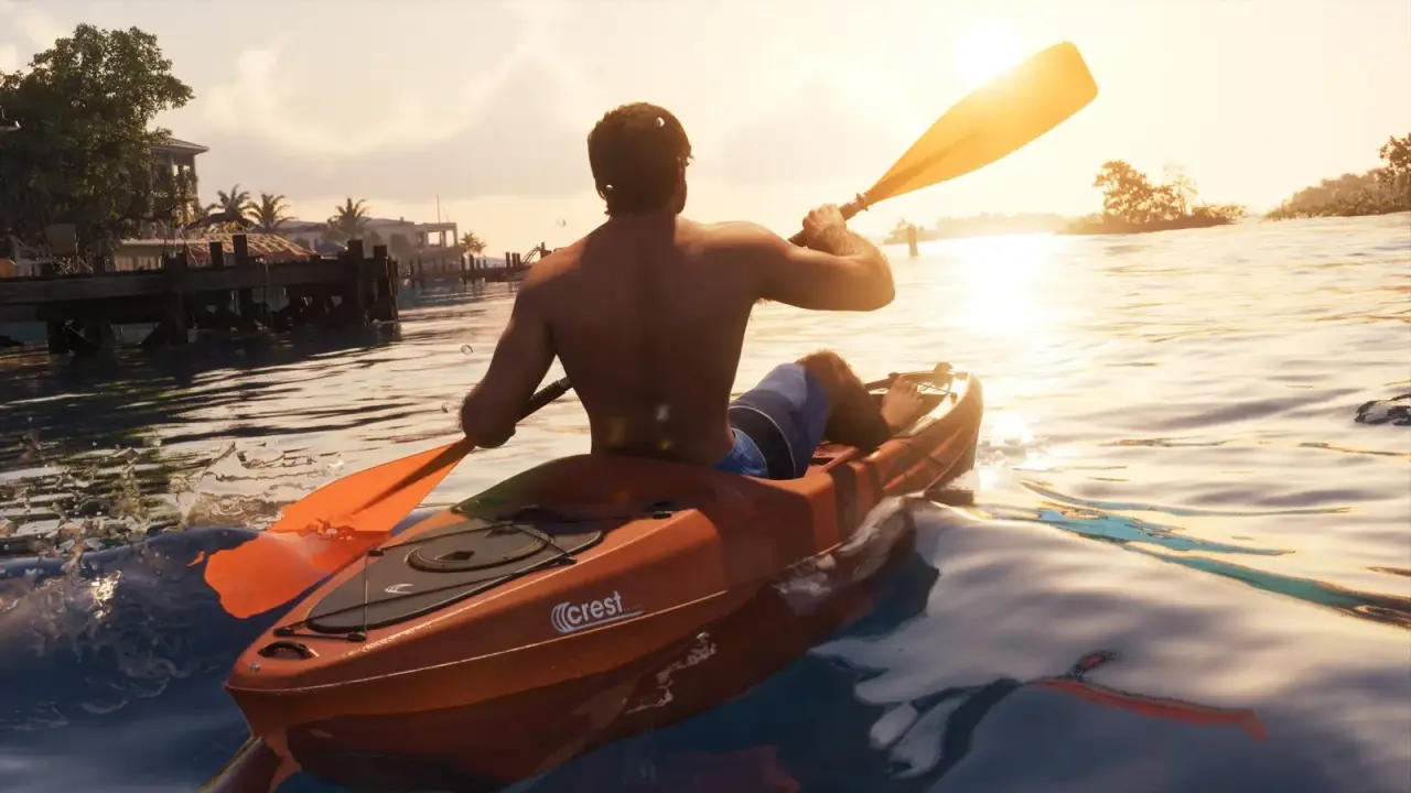 Jason paddling an orange GTA 6 Crest Kayak across calm water at sunset